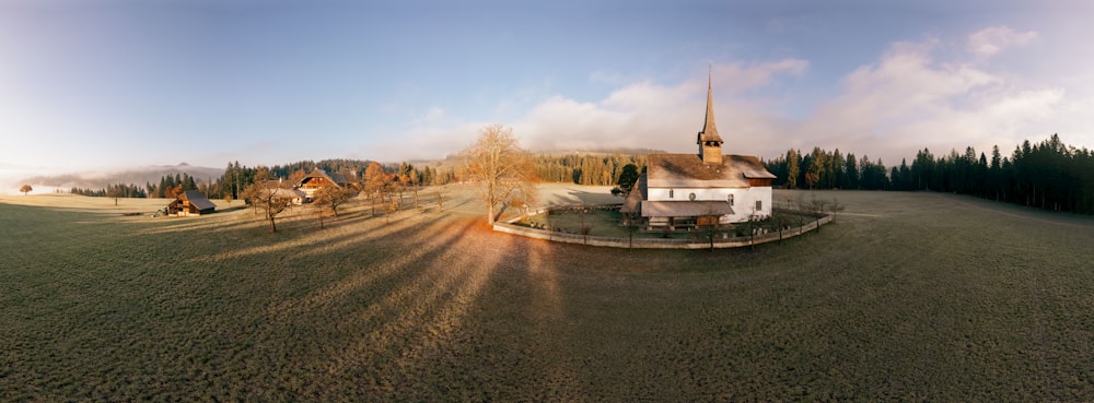 an aerial view of a church in the middle of a field