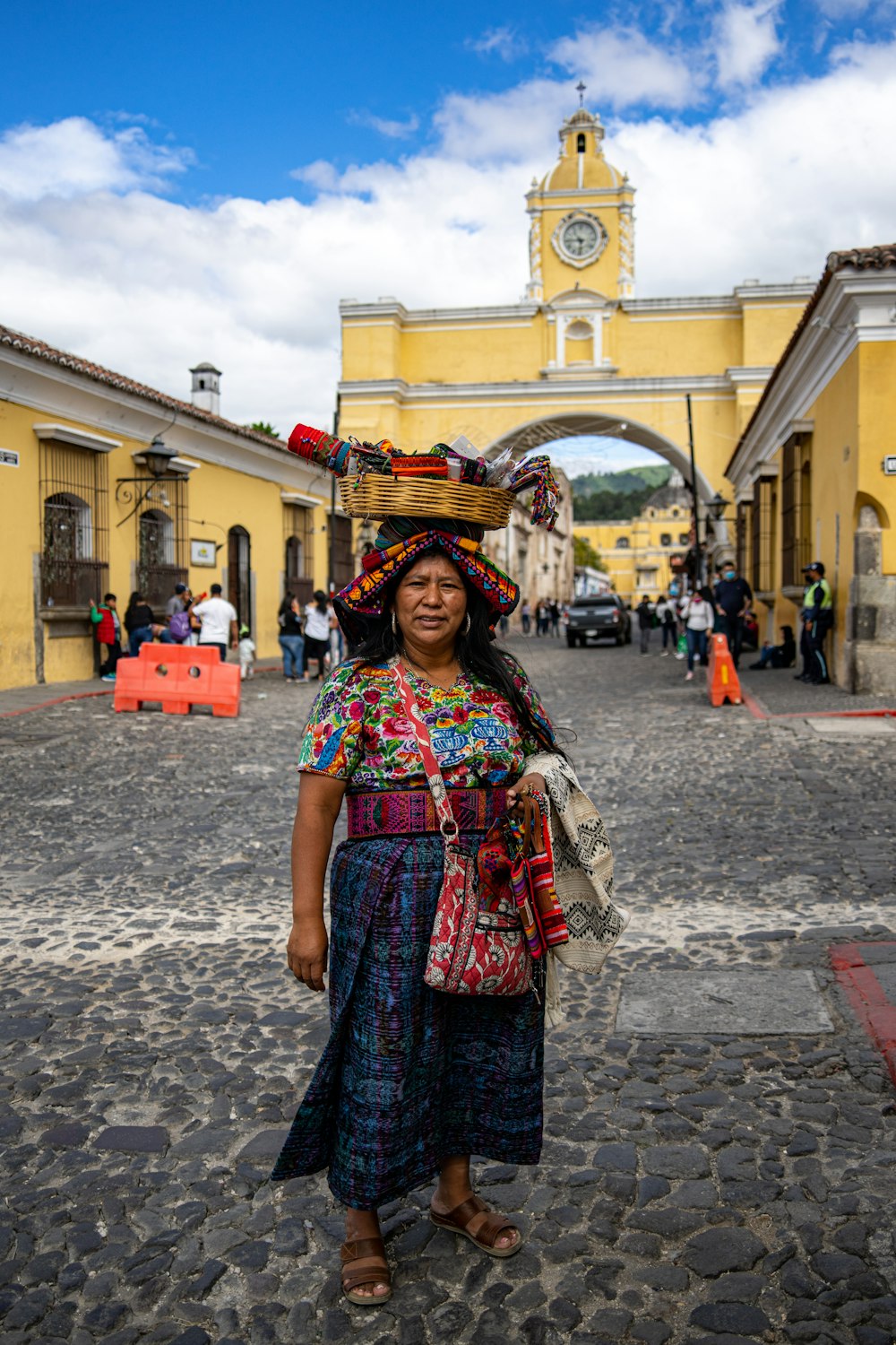 a woman standing in front of a yellow building