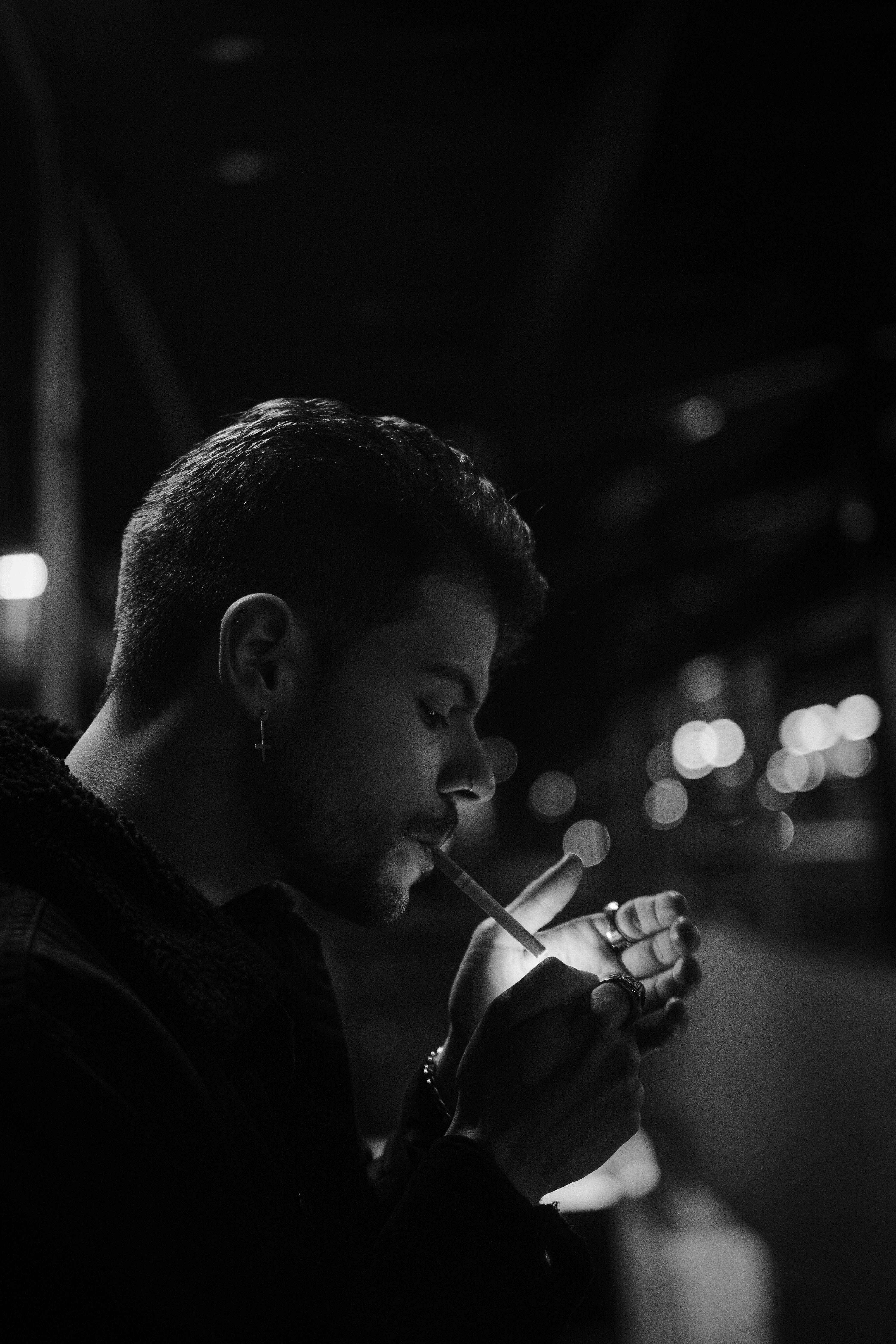 A man smoking a cigarette in a dark room photo – Free Portrait Image on  Unsplash