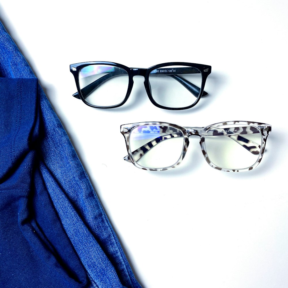 a pair of glasses sitting on top of a white surface