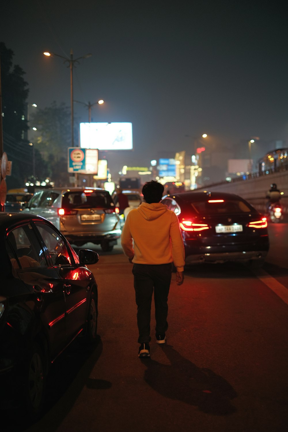 a man walking down a street at night