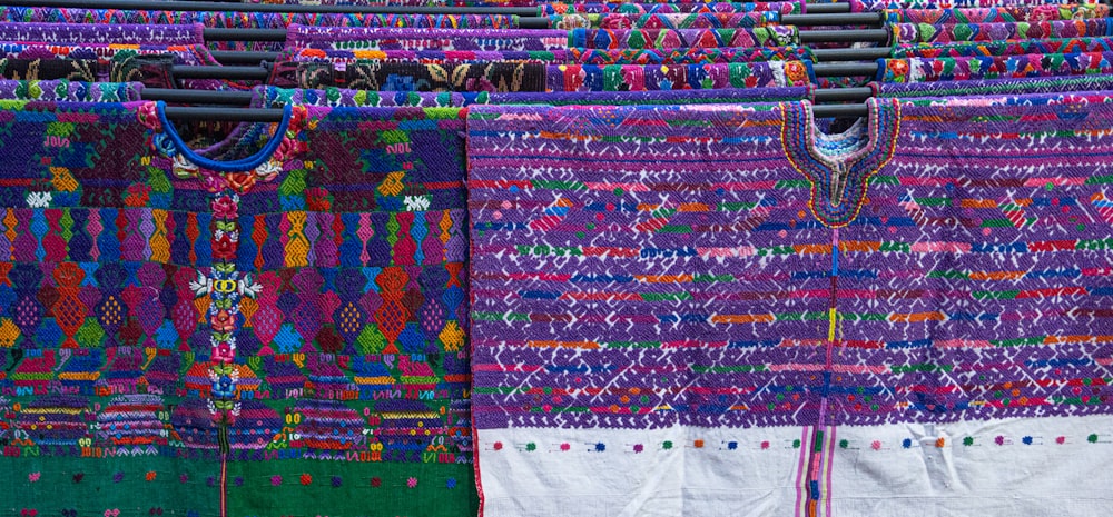 a group of colorful cloths hanging on a clothes line