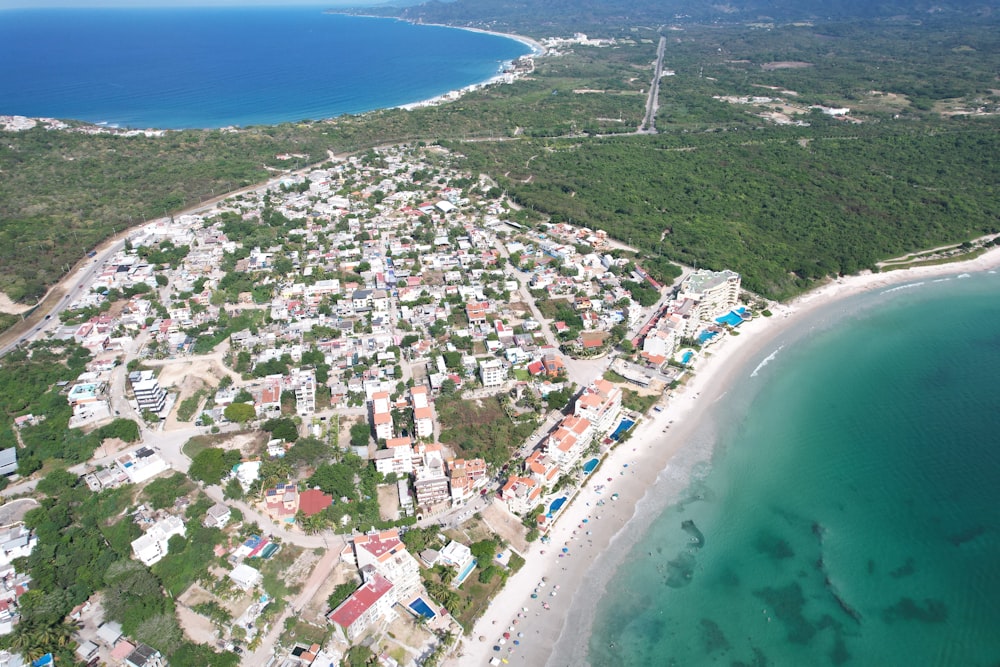 an aerial view of a small town by the ocean