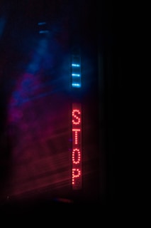 a sign that is lit up in the dark