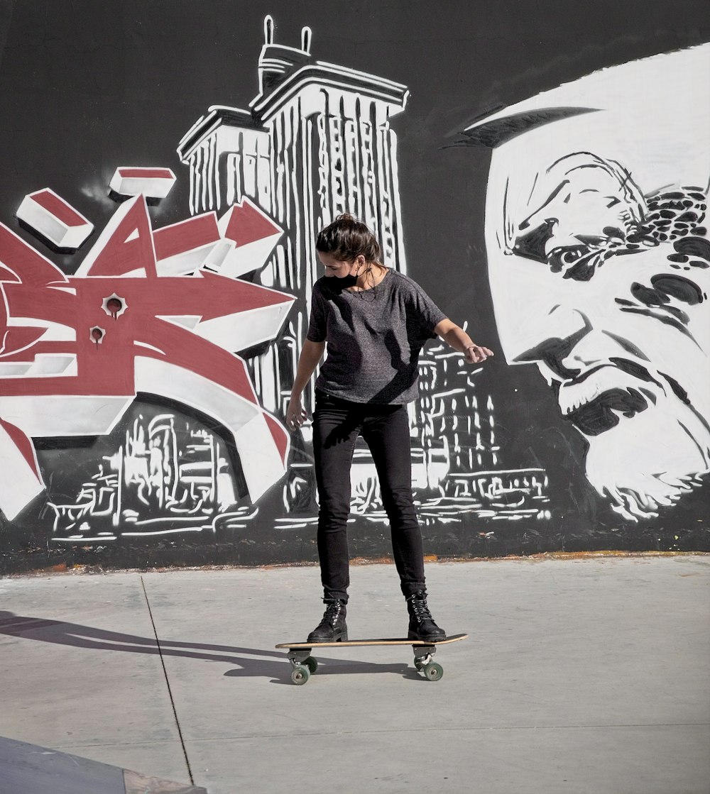 a man riding a skateboard down a sidewalk