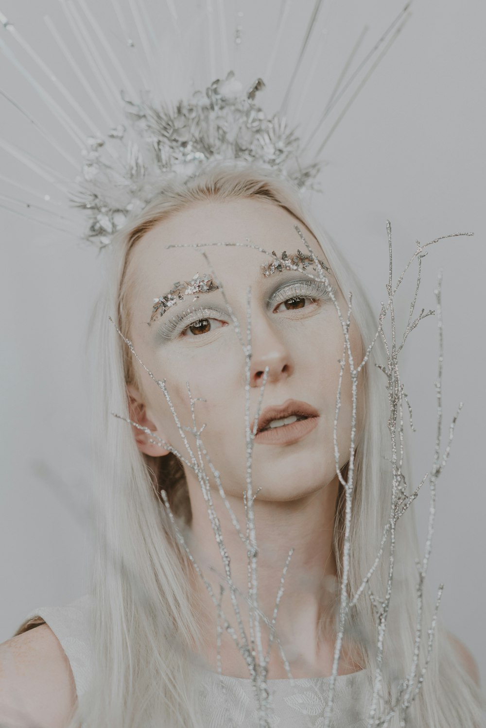 a woman with silver hair and a crown on her head