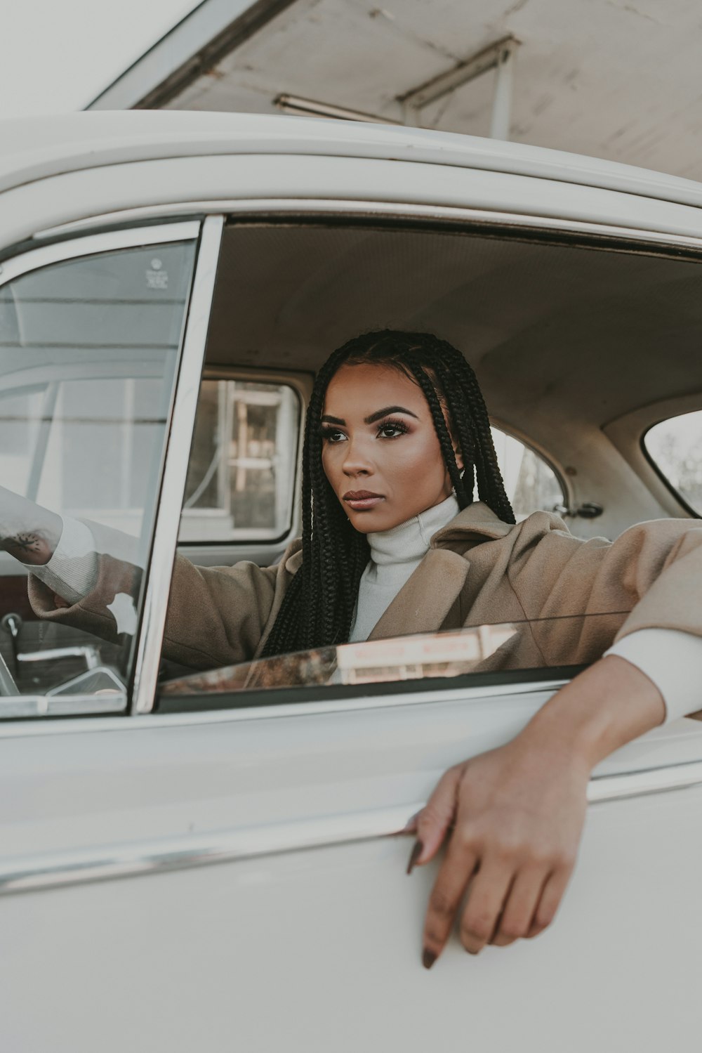 a woman sitting in a car looking out the window