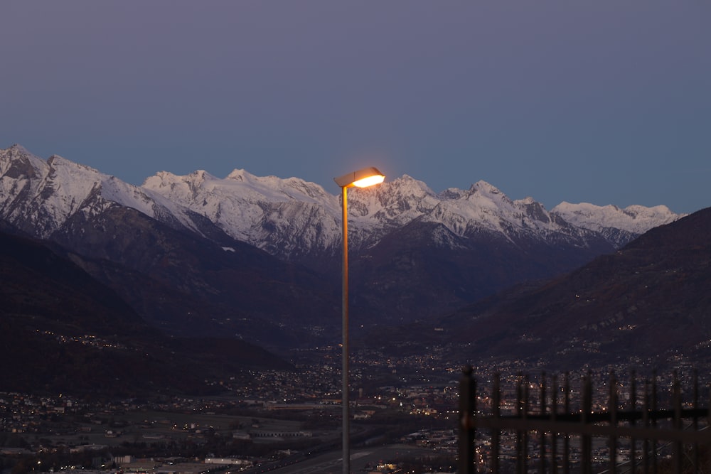 a street light in front of a mountain range
