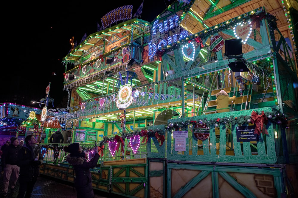 a brightly lit building with people looking at it