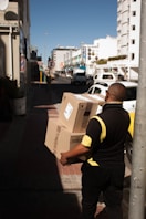 a man with a box on a city street