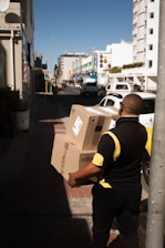 a man with a box on a city street