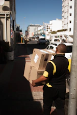 a man with a box on a city street