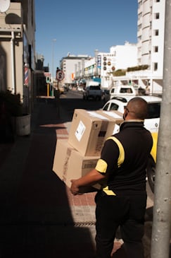 Delivery person holding parcel box