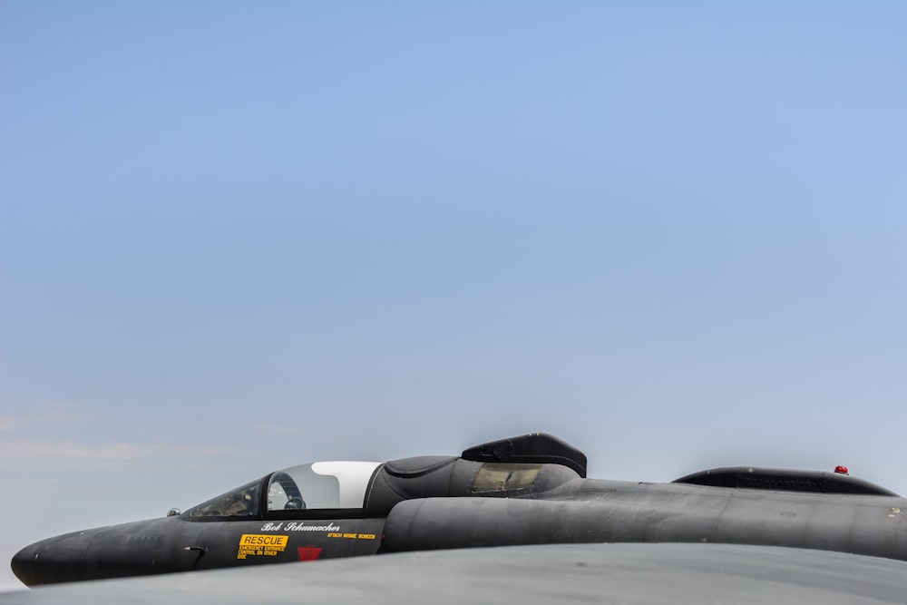 a fighter jet flying through a blue sky