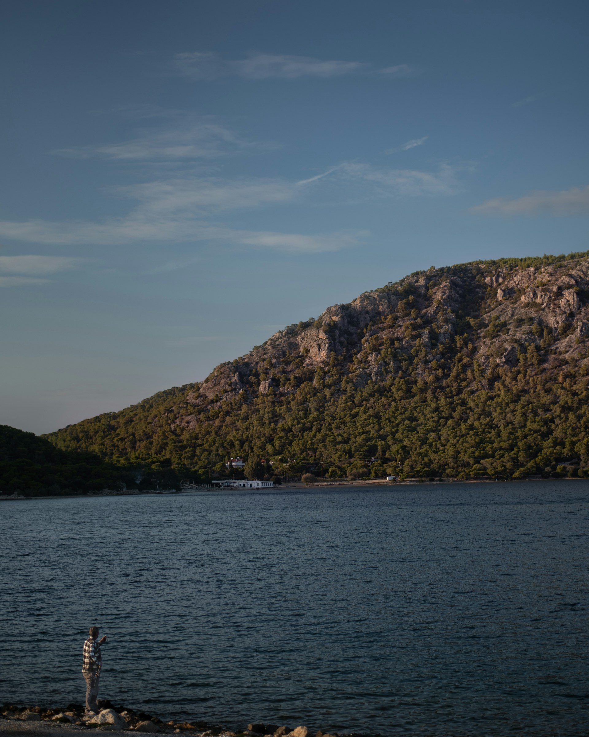 a body of water with a mountain in the background