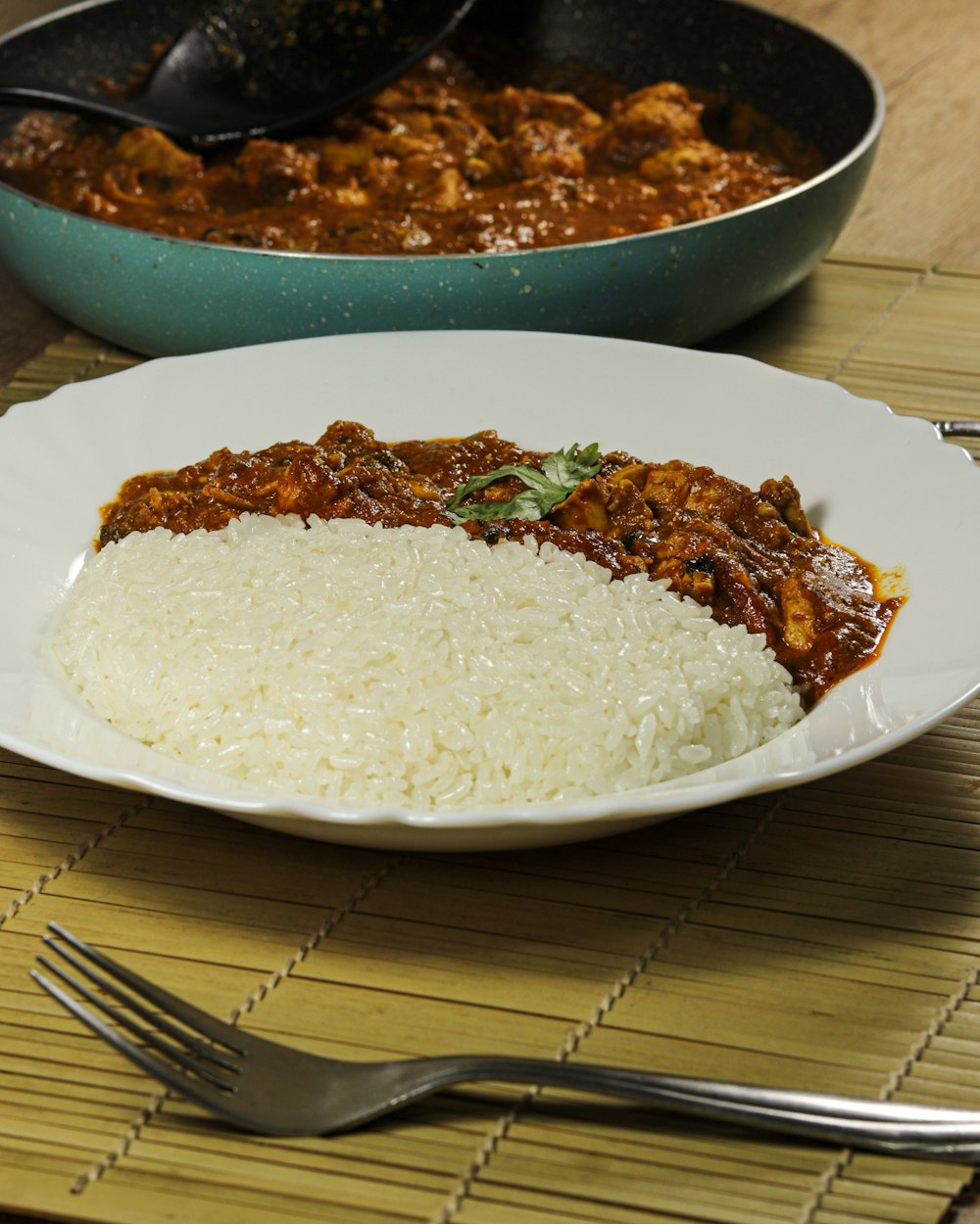 a white plate topped with rice covered in sauce