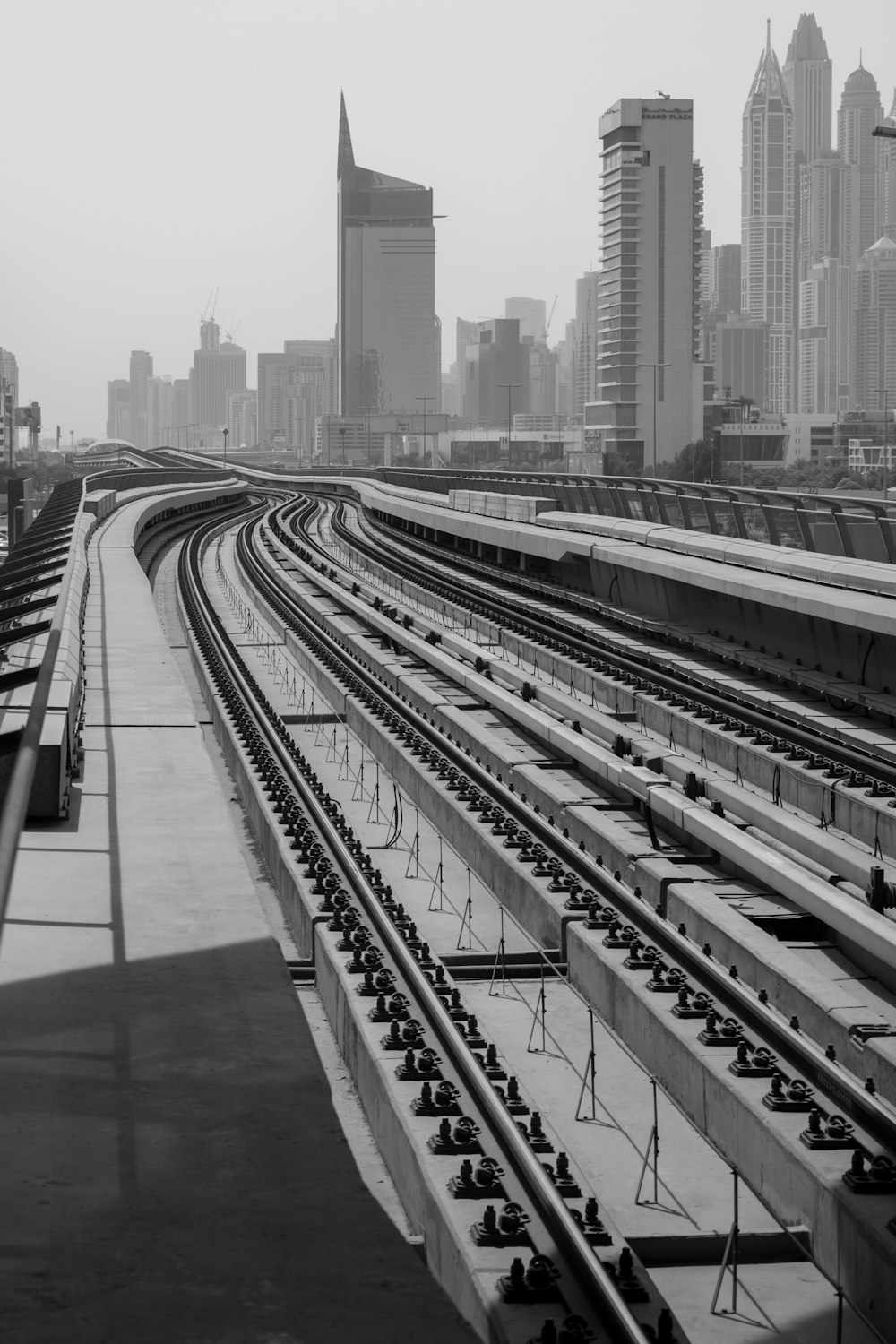 a black and white photo of a train yard