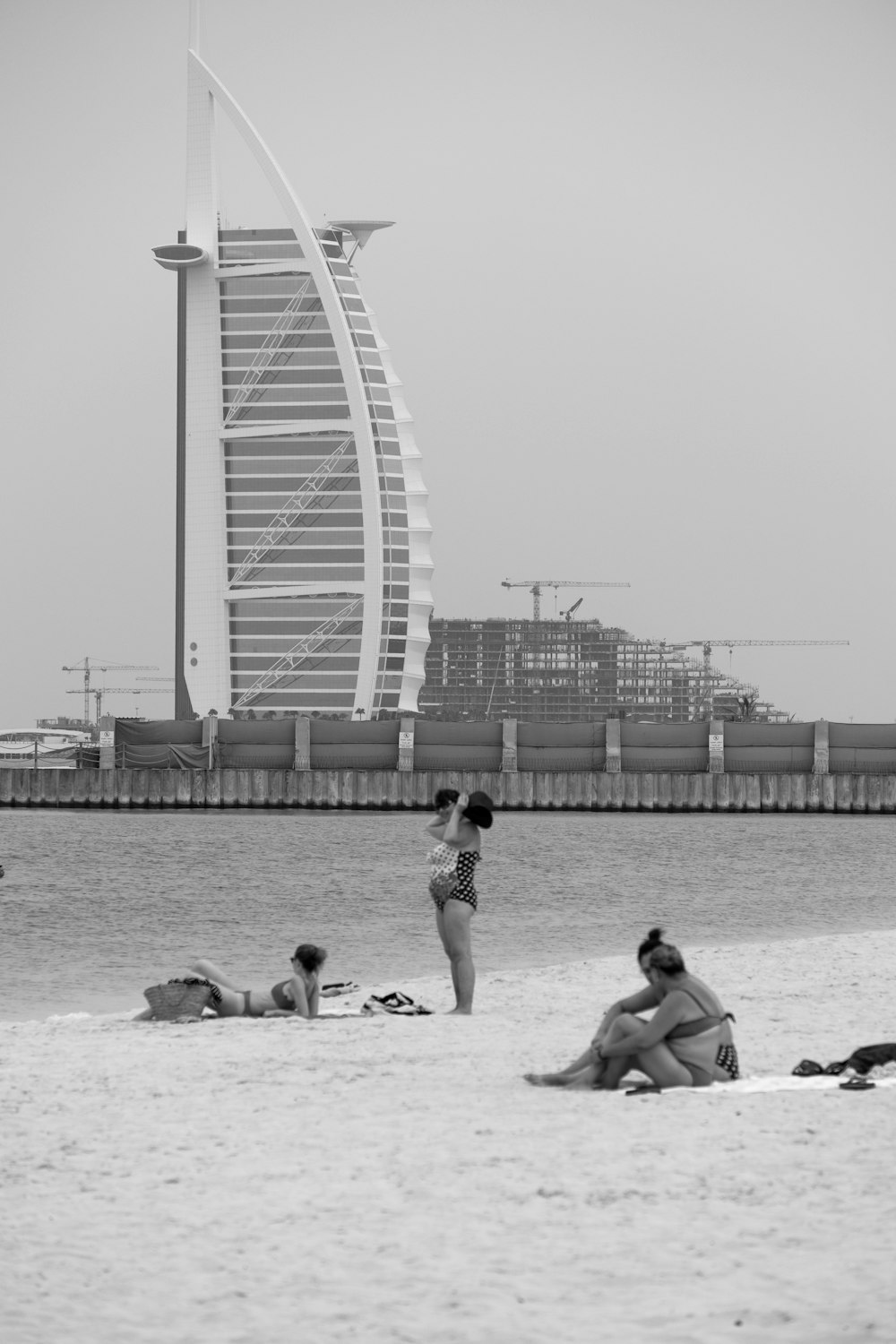 a black and white photo of people on the beach