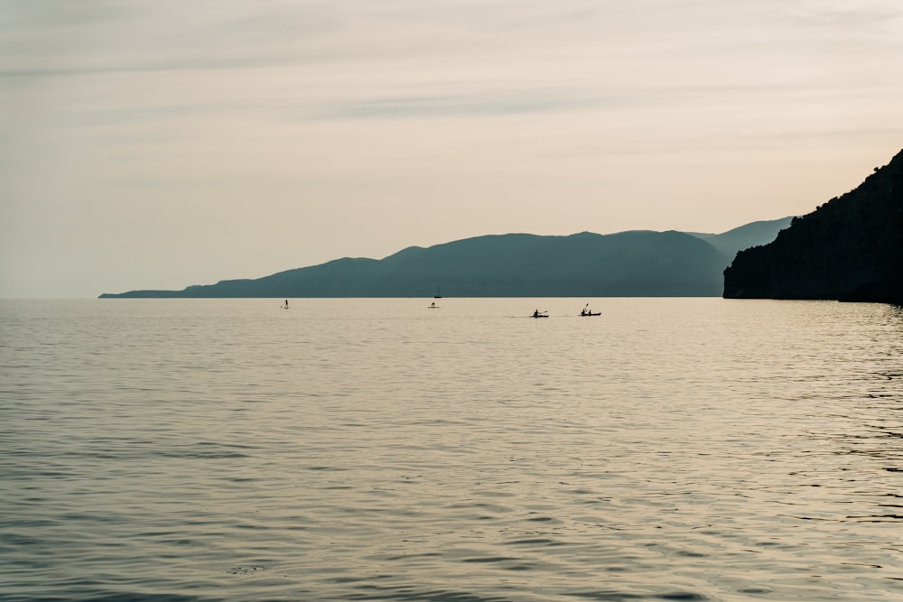 a large body of water with mountains in the background