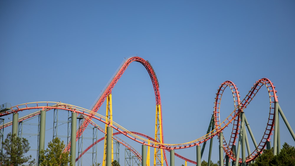 a roller coaster going down a hill in a park