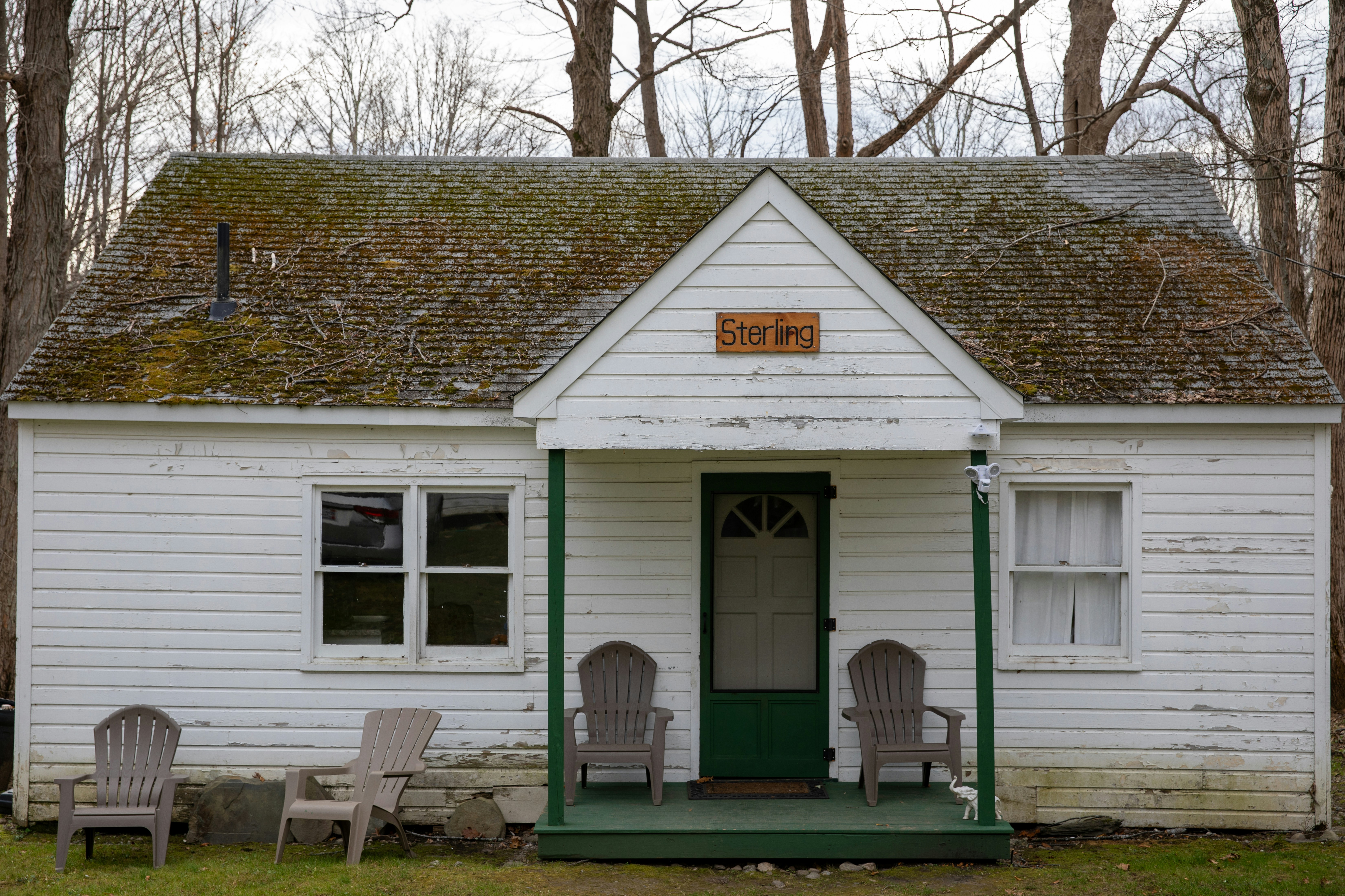 a small white house with a green door