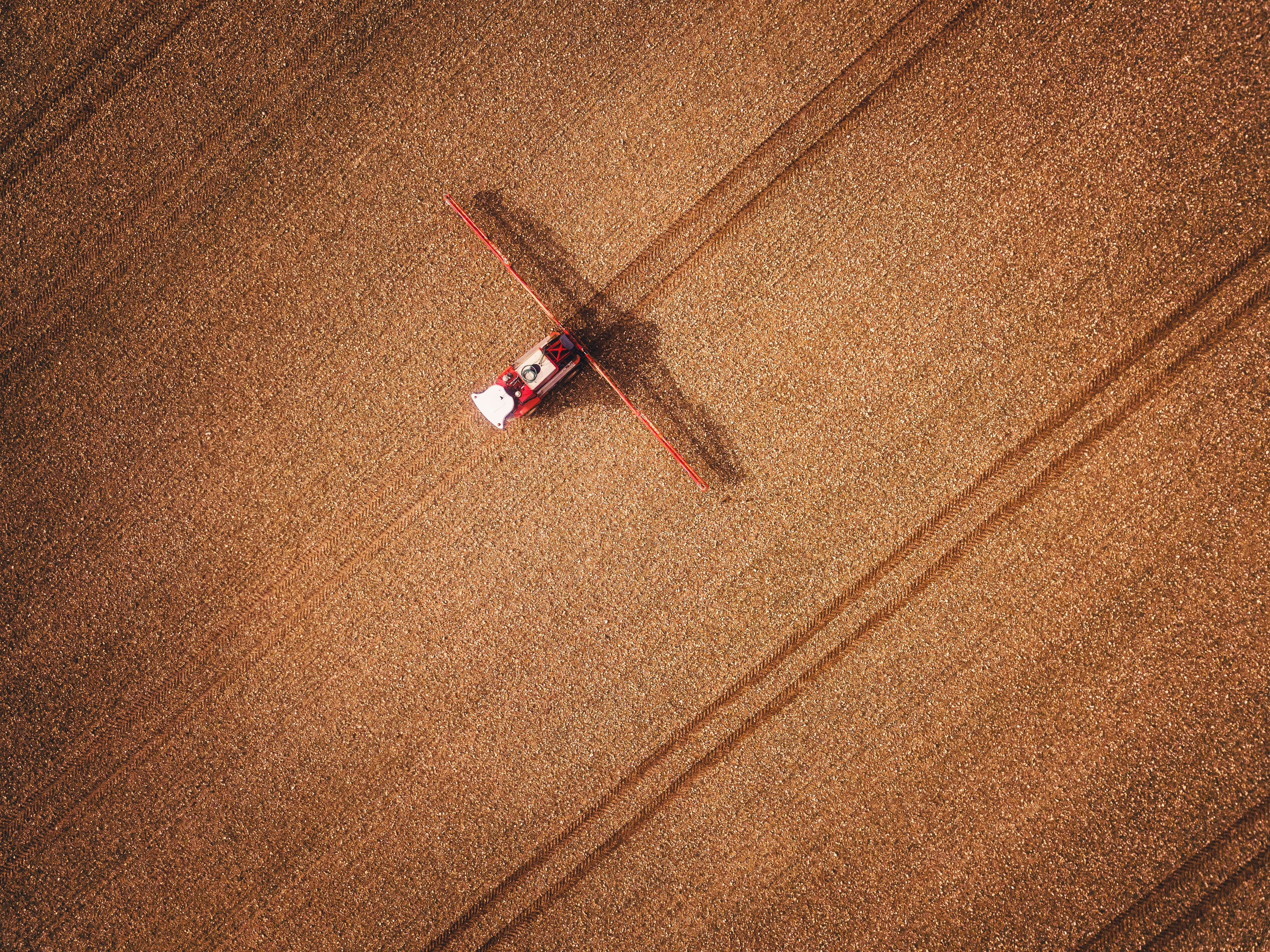 an aerial view of a red truck in a field