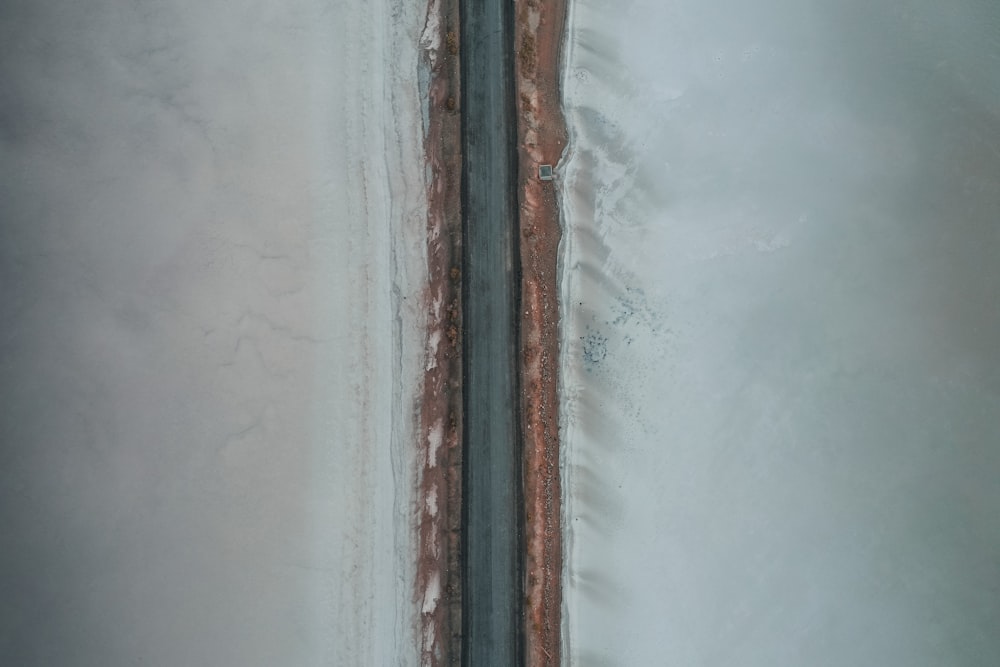 an aerial view of a road in the snow