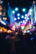 a person taking a picture with a cell phone
