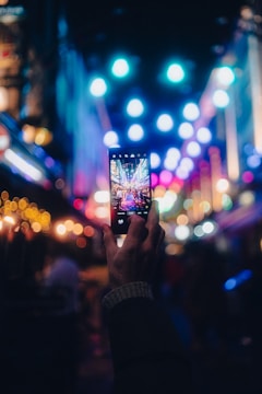a person taking a picture with a cell phone