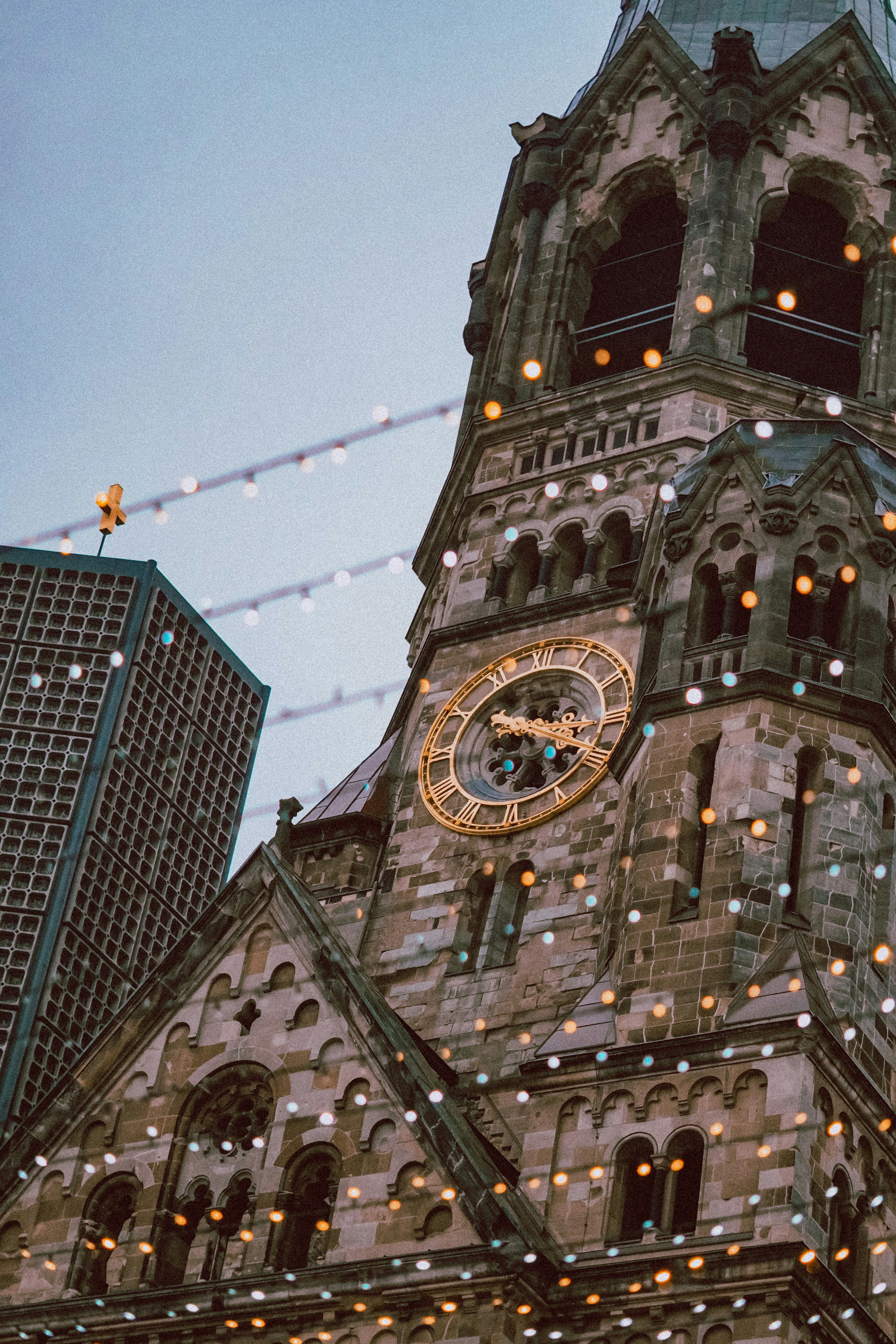 A large building with a clock on the front of it photo – Free Blue ...