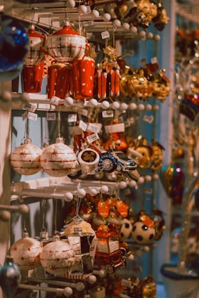 a bunch of ornaments are hanging on a rack