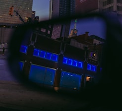 a view of a building through a rear view mirror