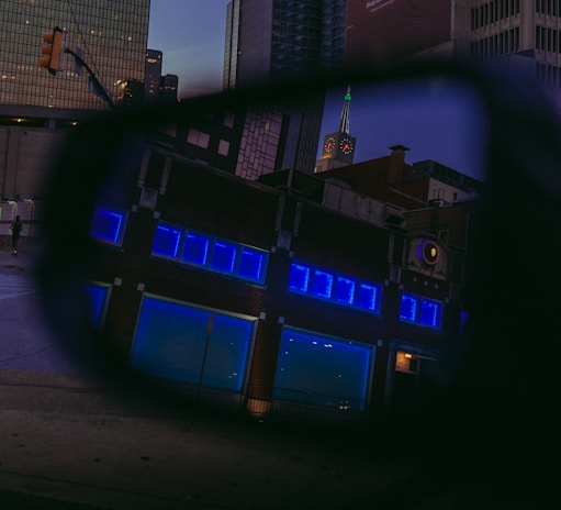 a view of a building through a rear view mirror