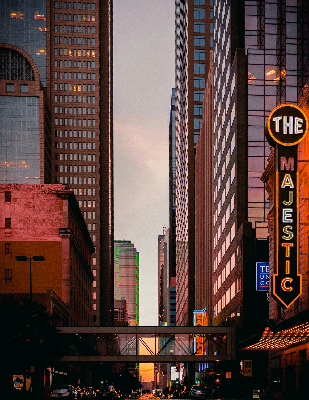 a city street filled with traffic and tall buildings