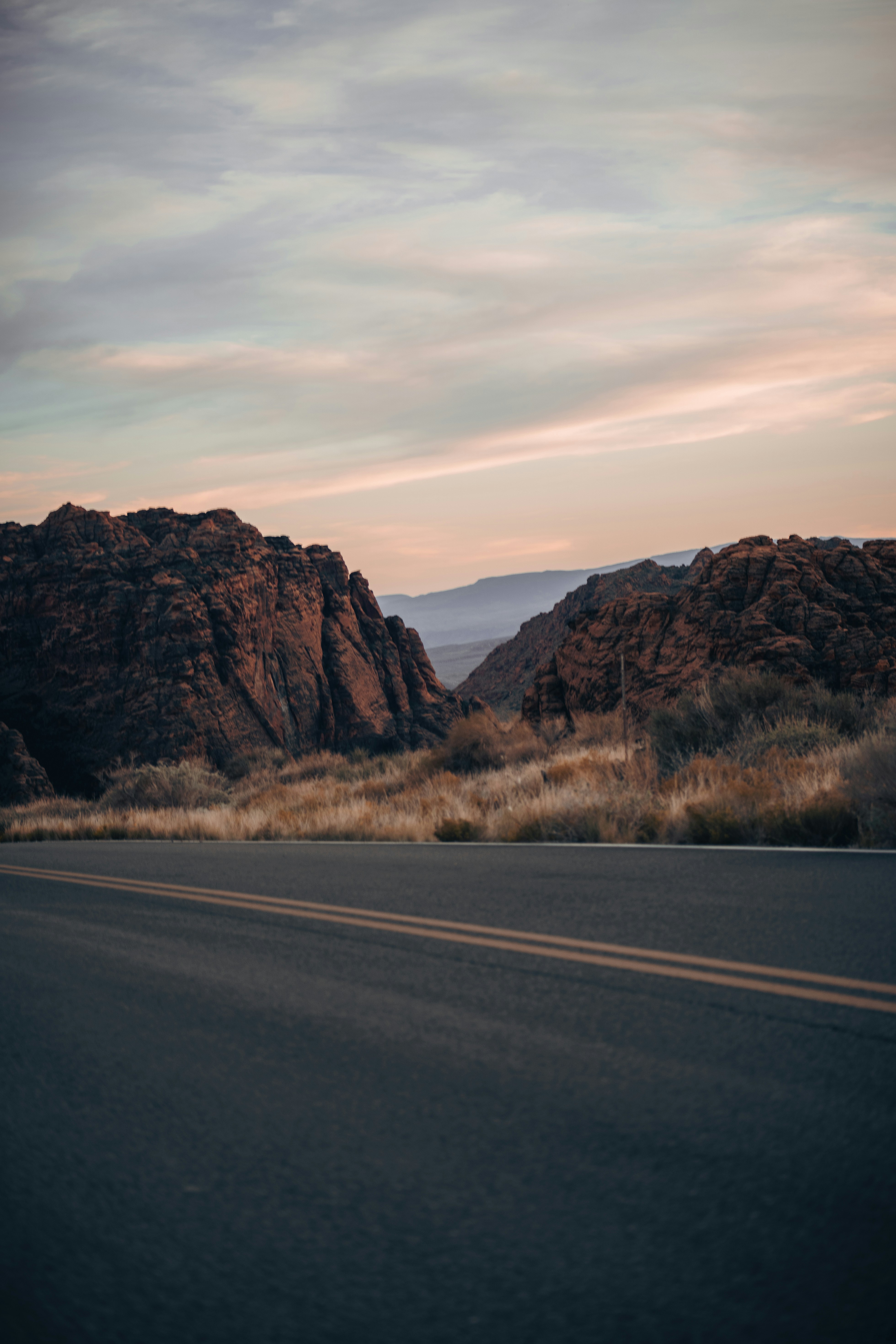 a car driving down a road in the desert