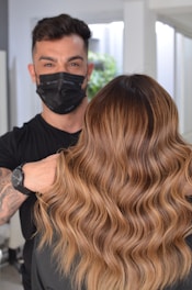 a man in a black mask and a woman with blonde hair