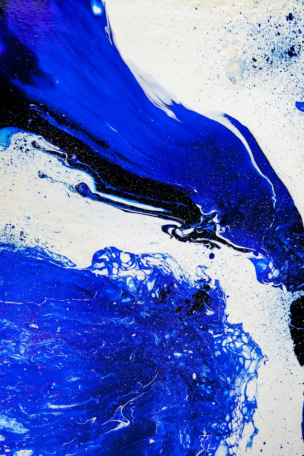 a blue and white abstract painting on a white background