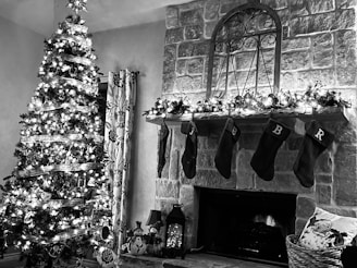A beautifully painted fireplace mantel decorated with garlands and stockings.
