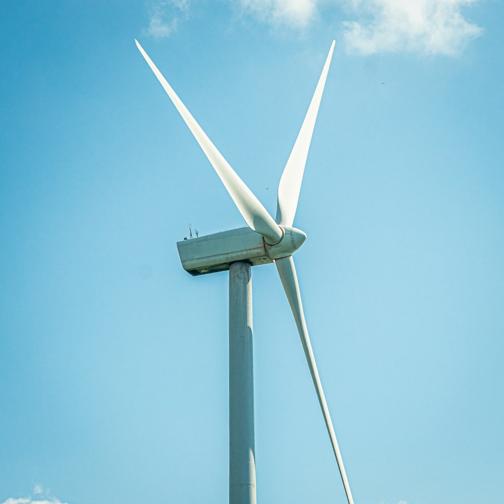 a wind turbine is shown against a blue sky