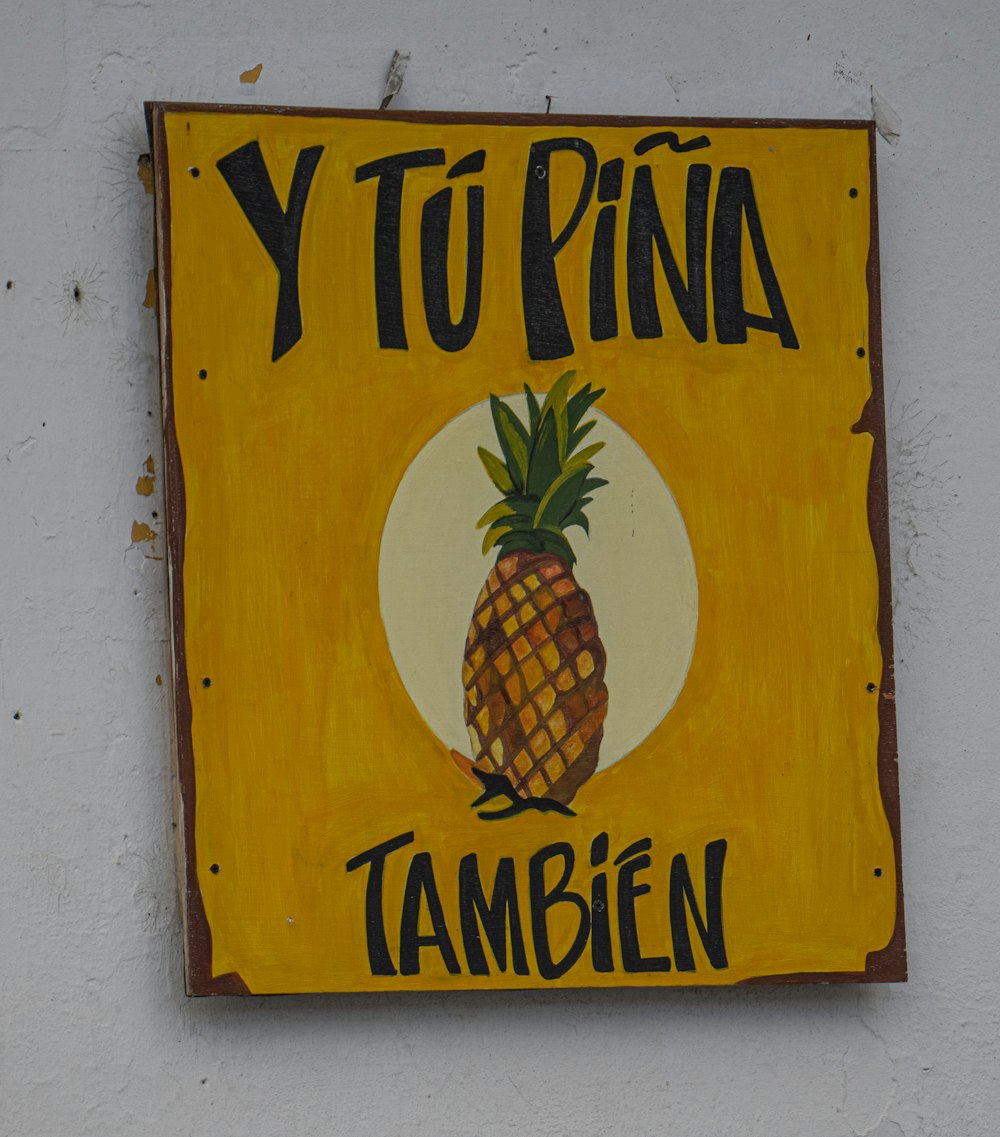 a yellow sign with a pineapple on it