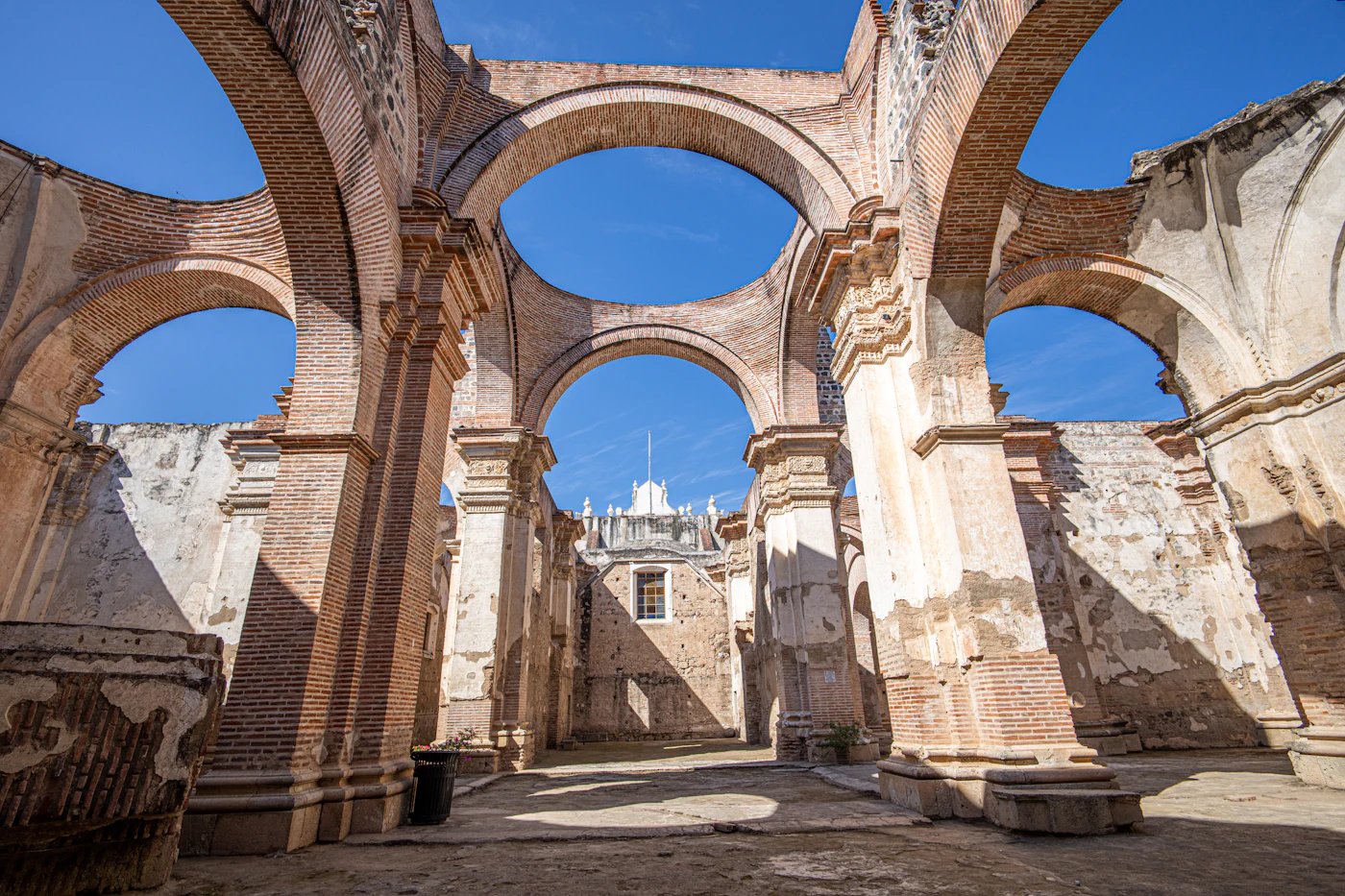 Colonial arches with a clock tower behind them in Antigua