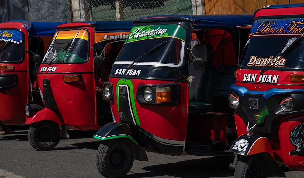 a row of colorful tuk tuks parked next to each other