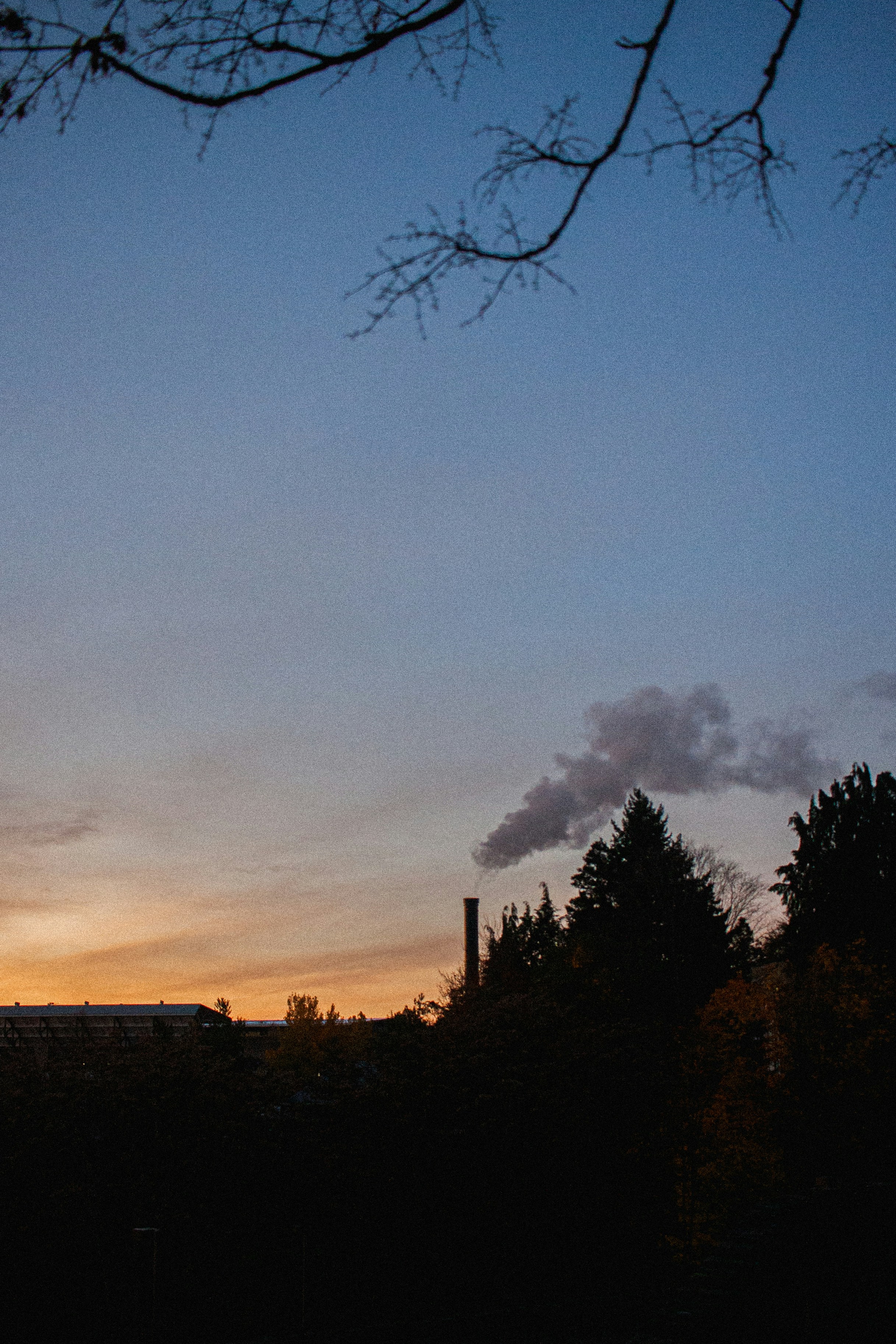 a view of a factory with smoke coming out of it