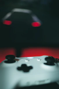 Close-up of hands on a sleek gaming controller with glowing dnxcoin.online logo in background.