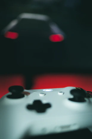 Close-up of a sleek LED video controller with glowing buttons in a dark room