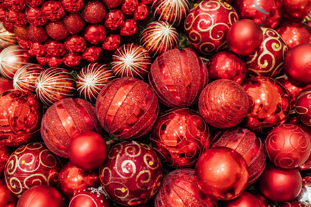 a pile of red christmas ornaments sitting next to each other