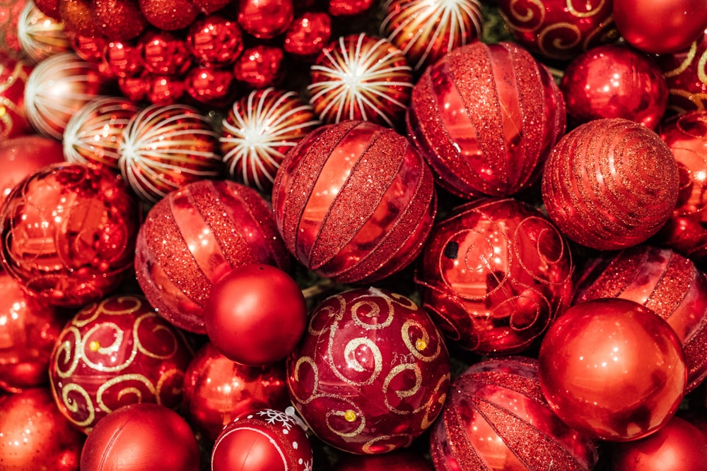 a pile of red and gold christmas ornaments