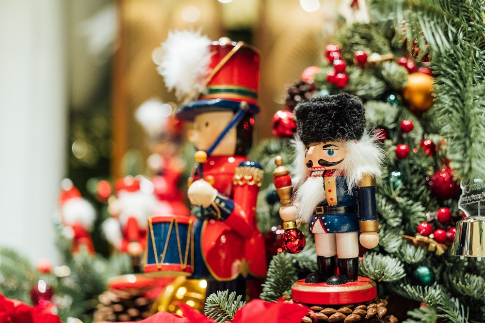 a nutcracker and soldier figurine on display in front of a christmas