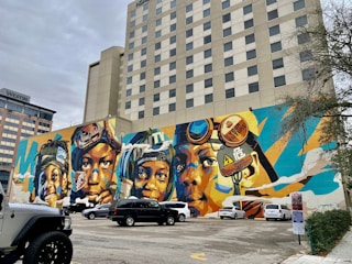 A vibrant street mural painted with the Westawk logo and dynamic patterns.