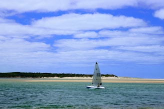 A luxurious sailboat gliding through calm ocean waters.